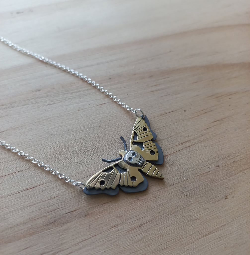 Death Moth Pendant made from a combination of oxidised Sterling Silver and Brass  and attached to a Sterling Silver chain