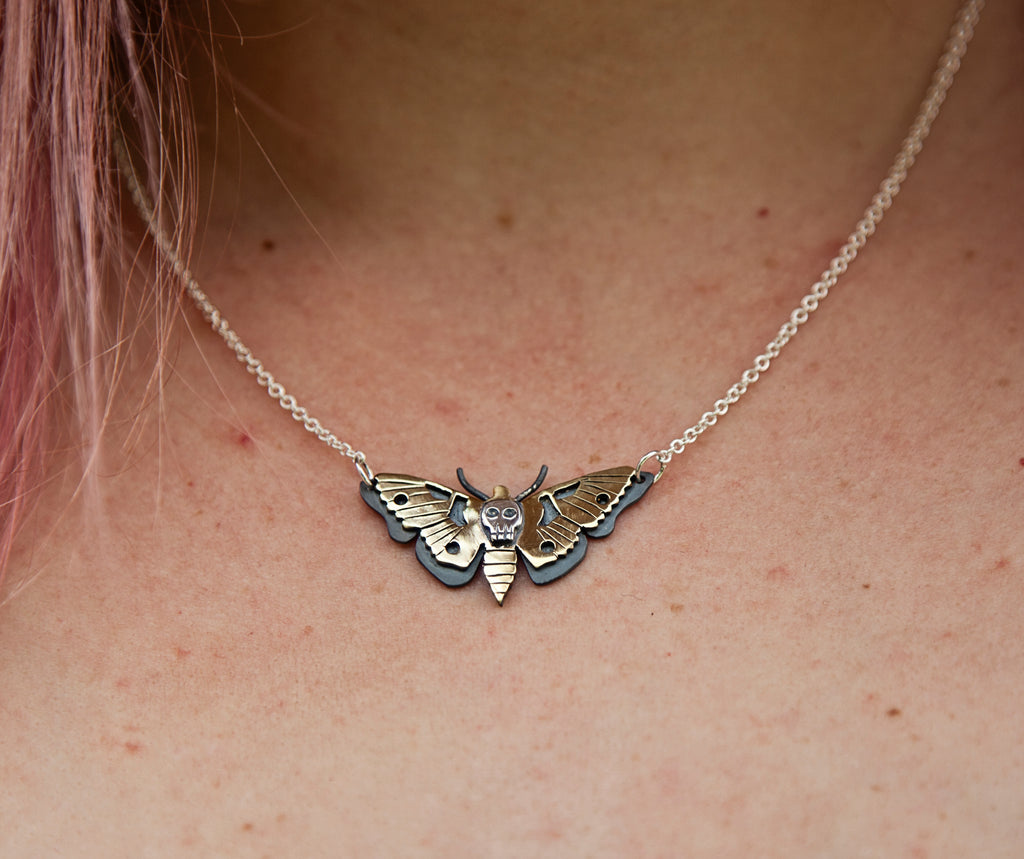 Death Moth Pendant made from a combination of oxidised Sterling Silver and Brass  and attached to a Sterling Silver chain