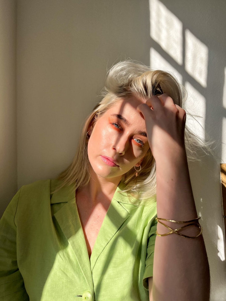 Model wearing Brass hammered Florence bangle 