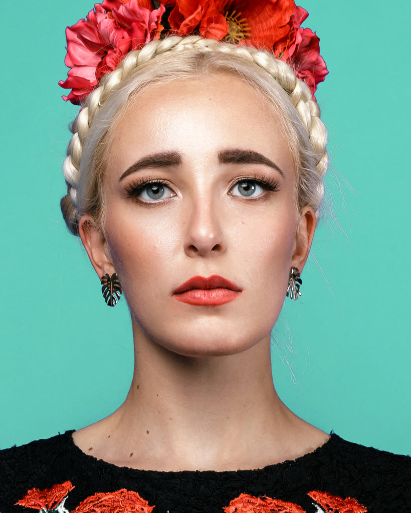 Model wears Bronze Monstera 3 stud with earring post and butterflies