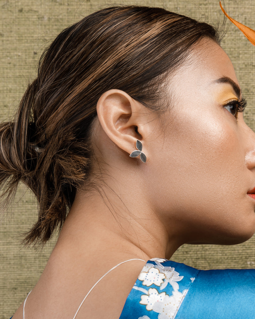 Model wearing the Sterling Silver 3 leaf Trilogy studs with earring post and butterflies